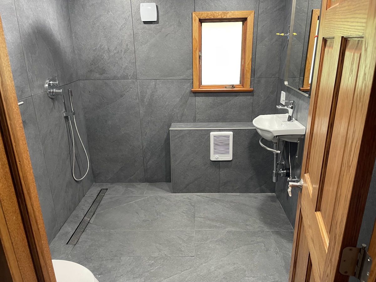Slate tile bathroom with floating sink