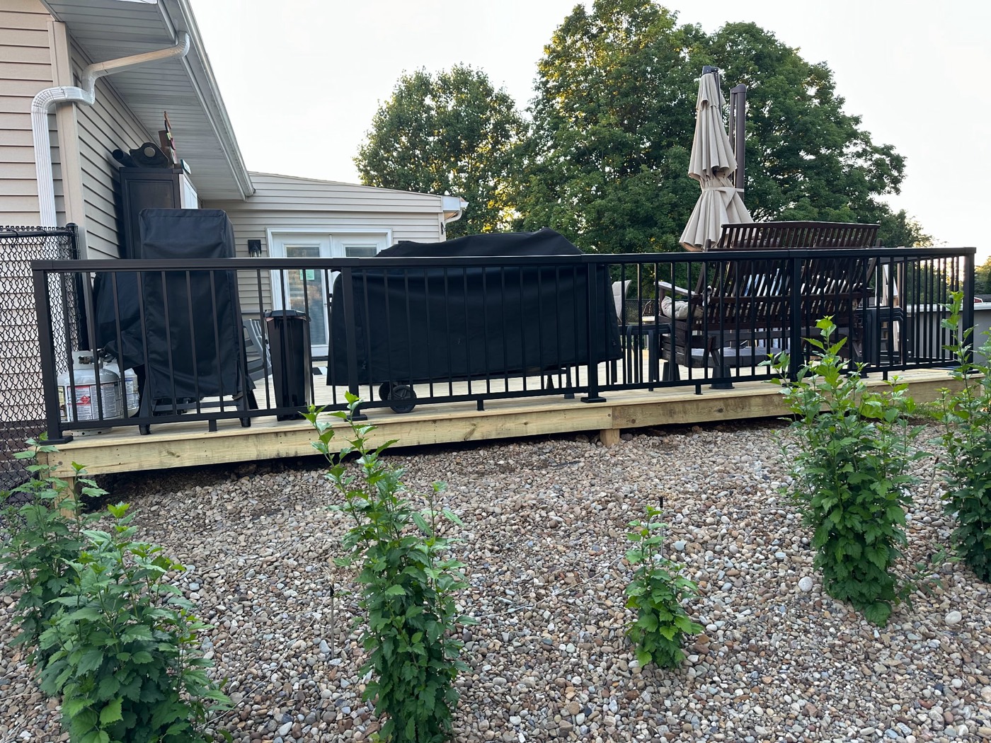 Deck railing and framing detail with fresh landscaping