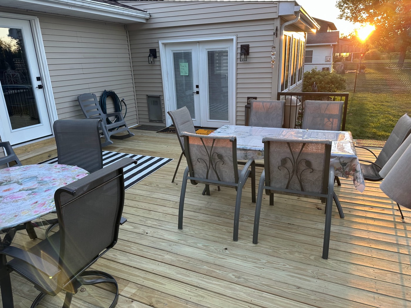 Completed backyard deck at sunset with outdoor dining furniture